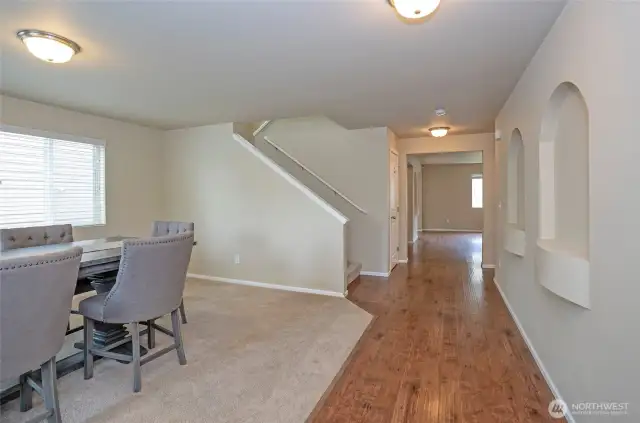 Laminate hardwood flooring adds charm as it flows into the heart of the home—family and kitchen spaces.