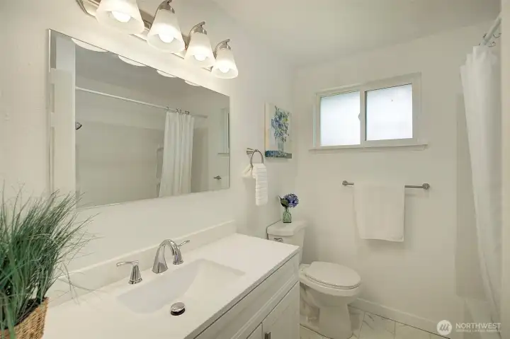 Main full bath in hallway.