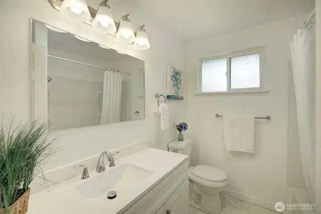 Main full bath in hallway.