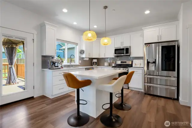 White cabinets, soft close drawers, brushed nickel handles with crown molding.