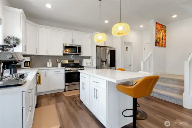 Solid quartz counter tops and stainless-steel appliances.