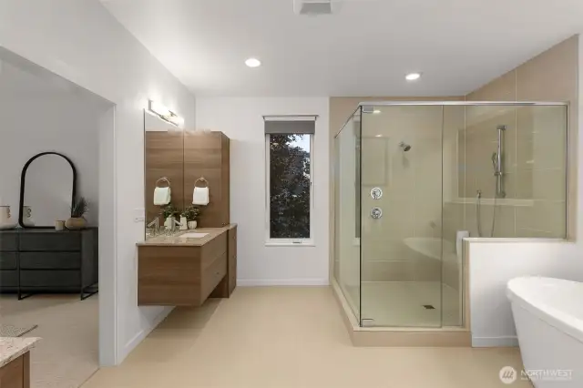Spa-inspired bathroom with soaking tub, spacious shower, and separate sink stations.