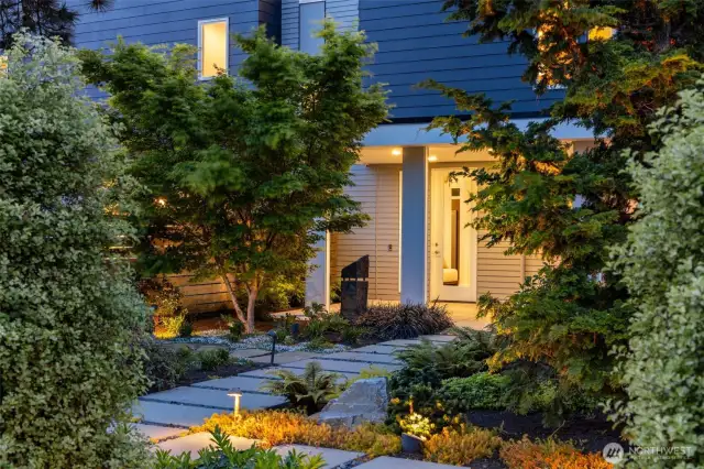 Exquisite landscaping in front and back and wide designer style paver walkways in front and back.