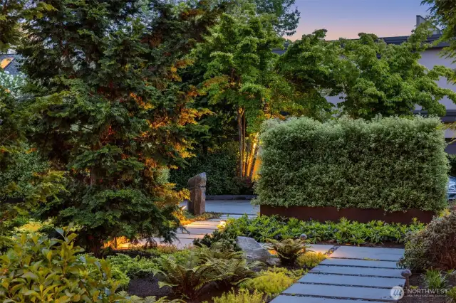 Exquisite landscaping in front and back and wide designer style paver walkways in front and back.