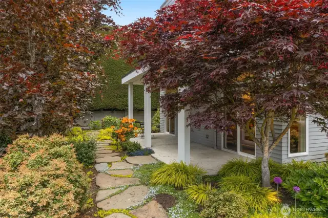 Exquisite landscaping in front and back and wide designer style paver walkways in front and back.