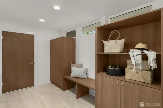 Welcoming entrance off the garage with built-in bench seat and ample storage.