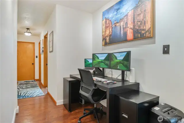 Spacious hallway is a great place for an office and also has pull down attic storage