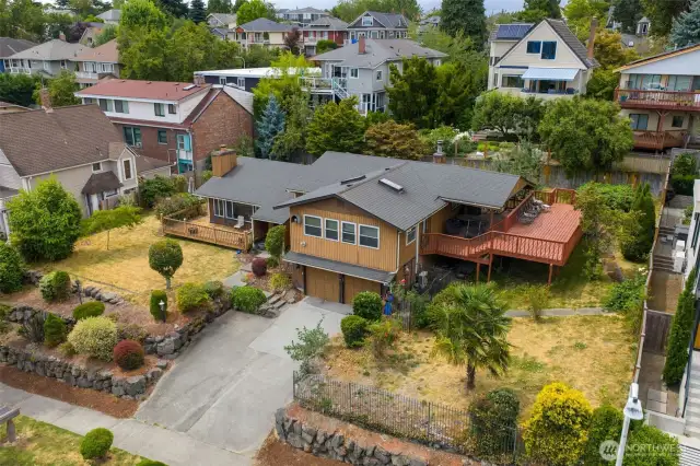 Custom and cutting edge in 1977, this home sits proudly on a prized 12,000sq ft. lot on a quiet street in Leschi above Lk WA.  It was built for its one and only owner and is now being listed for the first time since the original build, surrounded by other beautifully renovated and newly built homes.