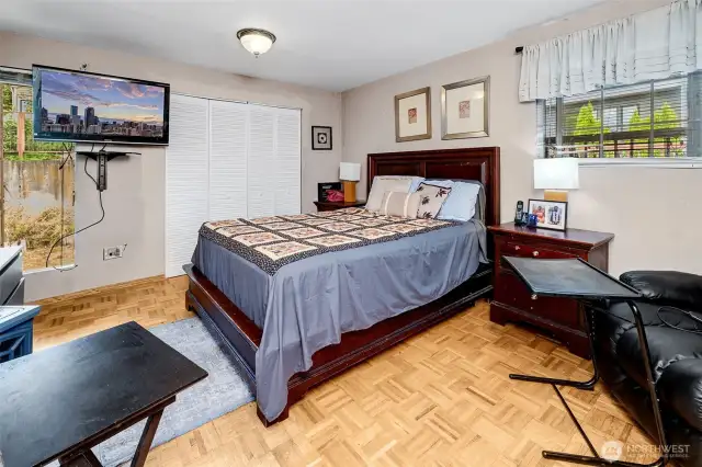 Primary bedroom has classic original parquet floors and private 3/4 bath. Great storage! 2 clothes closets plus linen storage.