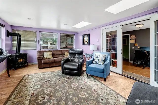 Comfortable library or home office off the upper hall leads to the sunroom.