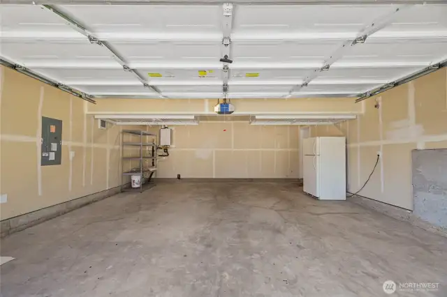 2 Car Garage has overhead racking, shelve and 2nd fridge that stays for new owners.