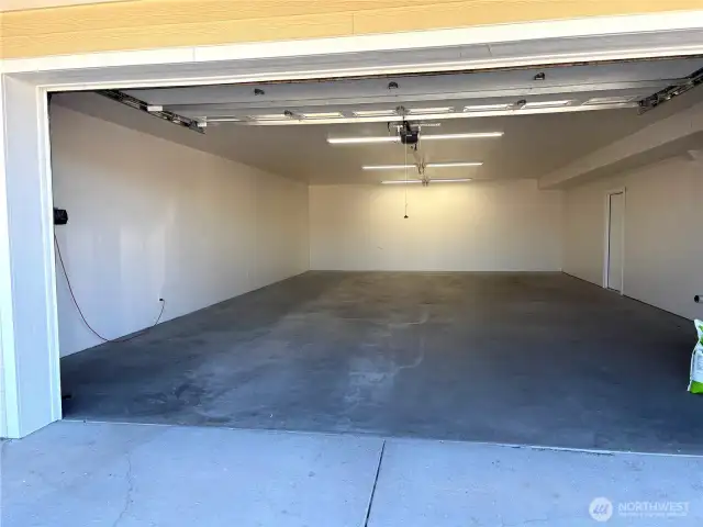 Large 4-car garage with heated floors, doubles as a full-size pickle ball court.