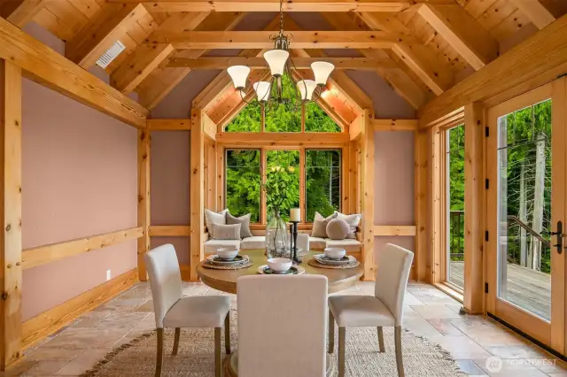 Grand dining room with window seat & french doors leading to deck