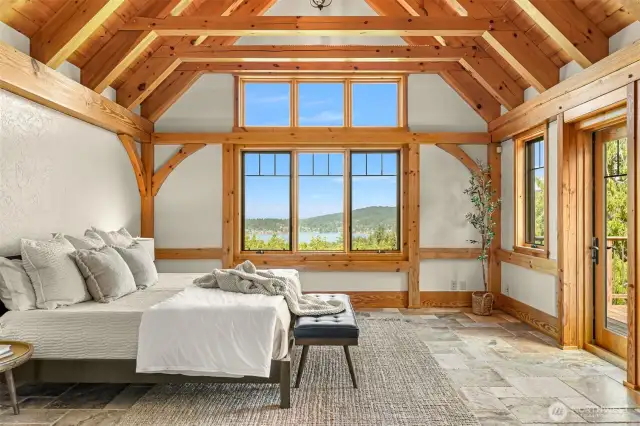 Primary bedroom located on the main level. View of Lake Whatcom, exposed vaulted beam ceiling.