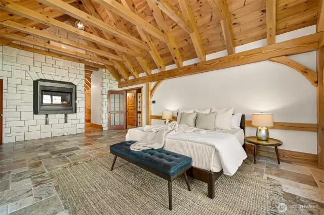 Gas fireplace in primary bedroom, with stone surround