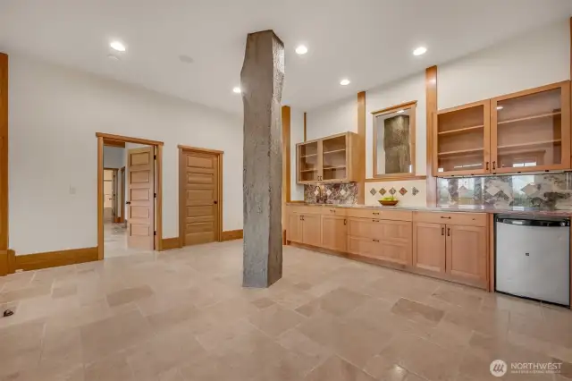 Lower level wet bar adjacent to the swim spa. Stone pillar