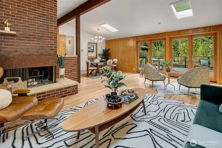 Living room flow to dining room, kitchen and back deck.