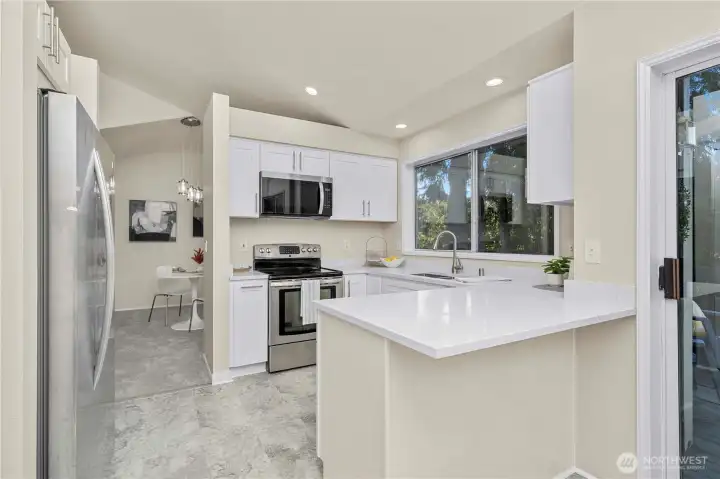 Kitchen opens to eat-in area by patio door and Dining room