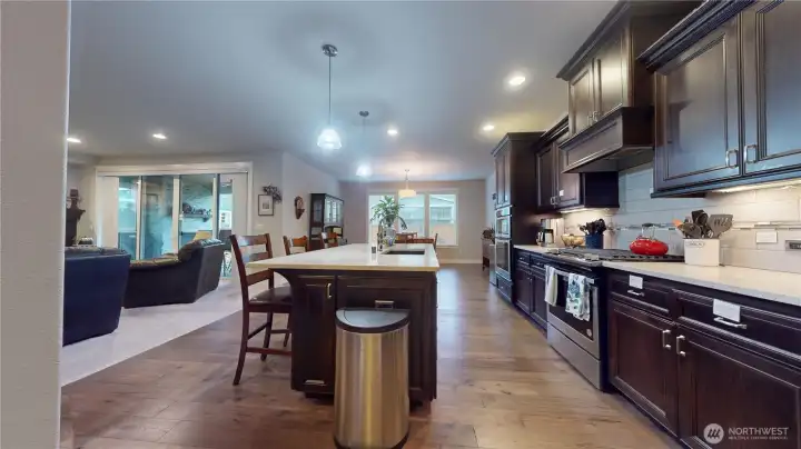 Open concept living space with chefs kitchen with island, granite counter tops and double oven