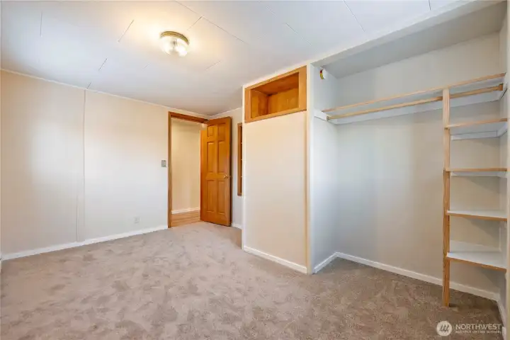 Downstairs bdrm #1 w/ custom built-in shelves and closet