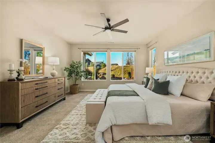 Primary bedroom overlooking the private backyard and permanent greenspace.
