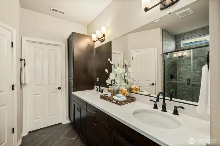 Beautiful primary bathroom with Quartz counters, statement hardware, tile floors and a huge walk-in closet.