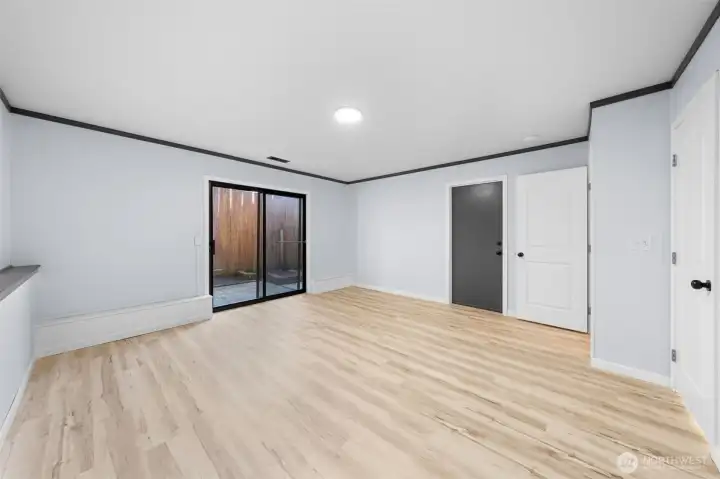 The grey door leads you into the garage and the white door allows you to create a whole separate room for additional privacy.  The slider leads to the backyard.