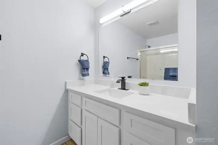 Hallway bath with new cabinets, granite counter tops, mirror and lights!