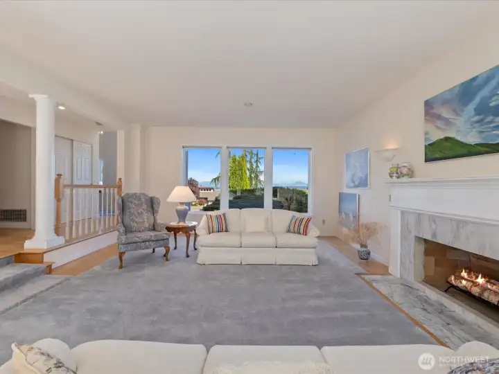 Lovely & large Living Room with fireplace & 2 walls of windows - bringing in lots of light year round.