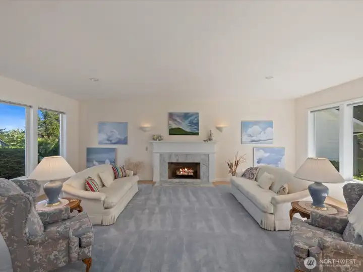 Lovely & large Living Room with fireplace & 2 walls of windows - bringing in lots of light year round.