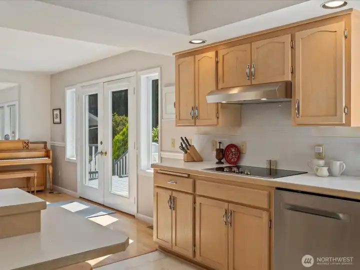 Large open Kitchen with center island, solid cabinets & lots of storage, new stainless steel appliances, subway tiles & fresh paint - overlooks the large Deck & Backyard.