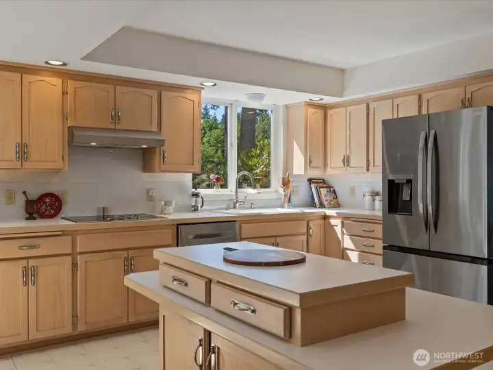 Large open Kitchen with center island, solid cabinets & lots of storage, new stainless steel appliances, subway tiles & fresh paint - overlooks the large Deck & Backyard.