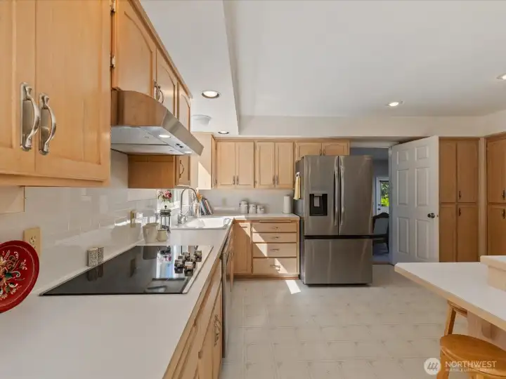 Large open Kitchen with center island, solid cabinets & lots of storage, new stainless steel appliances, subway tiles & fresh paint - overlooks the large Deck & Backyard.