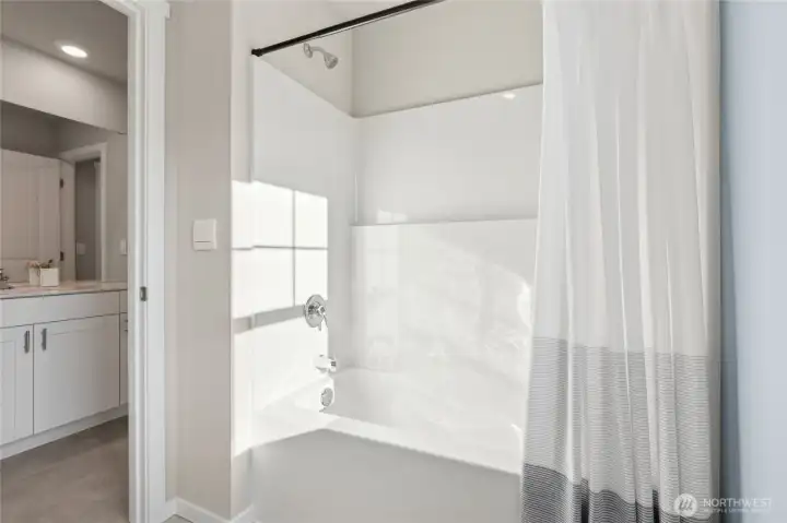 Full bathroom featuring a full-size shower/tub combination. Photos are representative only and may display different color package and/or upgrades. Full bathroom featuring a full-size shower/tub combination. Photos are representative only and may display different color package and/or upgrades.