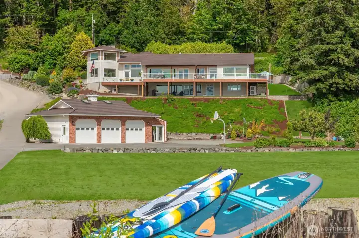 Imagine enjoying rare waterfront acreage with plenty of room for yard games, gatherings, and even basketball at the water’s edge.