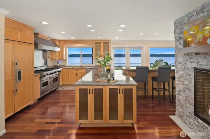 The chef’s kitchen is equipped with commercial-grade Viking and Sub-Zero appliances, abundant storage, and a huge walk-in pantry designed to accommodate even the most discerning cook.
