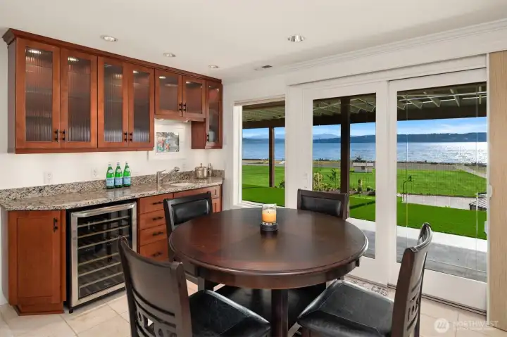 The wet bar, complete with a wine cooler, is conveniently located just inside from the hot tub—perfect for pouring a glass of wine and unwinding after a day on the water.