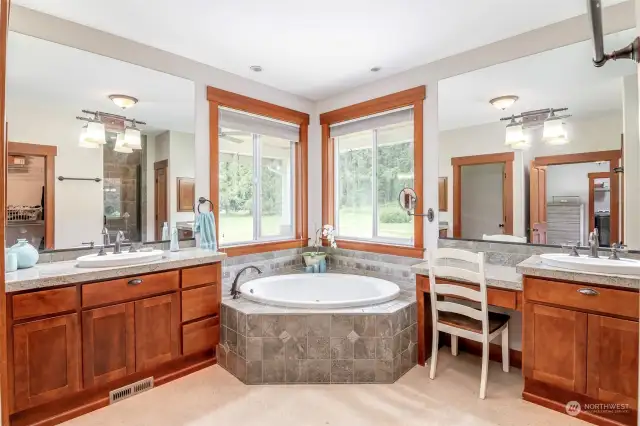 Primary bathroom with dual vanities and soaking tub