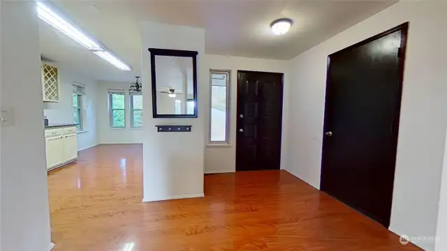 Foyer" Front door. Door to garage. Entrance to kitchen.