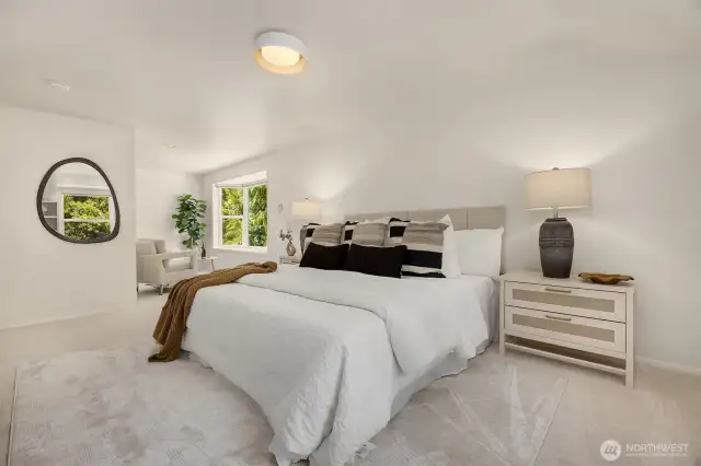 Spacious primary bedroom with relaxing lounge area
