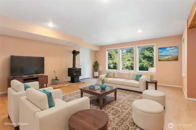 Bright and open lower-level living area with gas fireplace and plenty of room to relax. ( Virtually Staged)