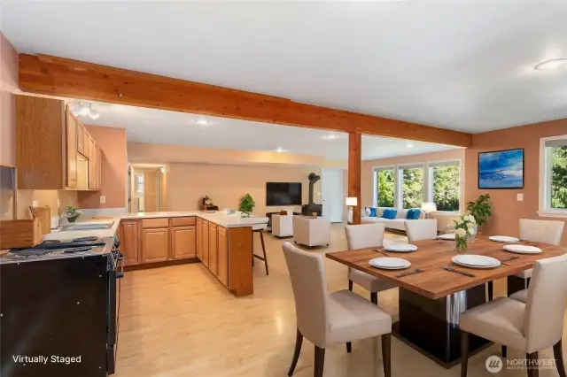 Virtually staged lower-level complete with spacious living room, dining area with gas fireplace, full kitchen, and laundry — ideal for extended living or guest quarters.