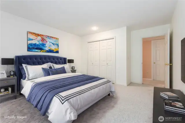 Virtually staged downstairs bedroom #1 featuring generous closet space and a roomy layout.