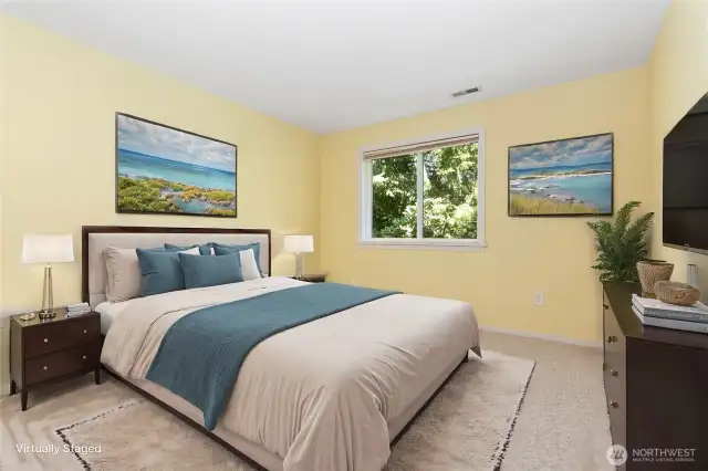 Virtually staged downstairs bedroom #2 featuring generous closet space and a roomy layout.
