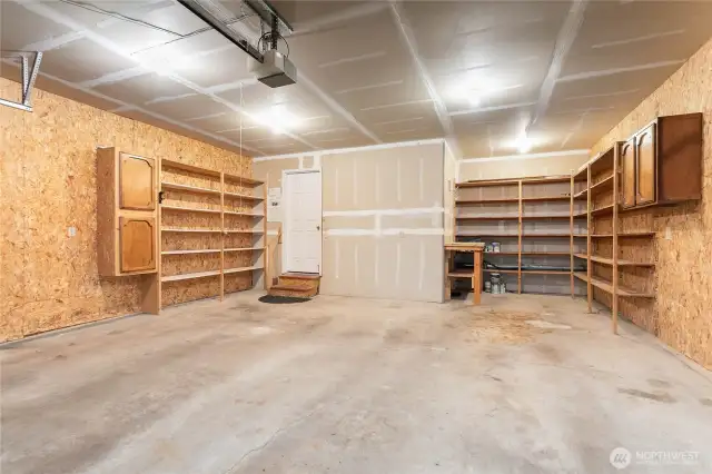 This roomy two-car garage with built-in shelving offers plenty of space for storage, hobbies, and weekend adventures.
