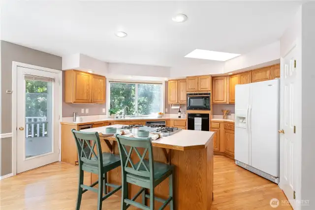 Cozy up at the eating bar in this open-concept kitchen—perfect for quick bites or socializing.