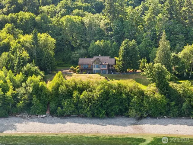 The house, the waterfront lot to the left of the home, and the 5 acres upland adjoining the home.   Notice the stairs to the beach.  The beach has been planted with oysters.