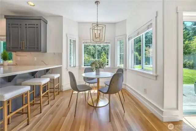 There is plenty of space to entertain in this large, updated kitchen that feature new cabinetry, quartz countertops and backsplash, refinished hardwood floors, 48" gas stove, and updated light fixtures.