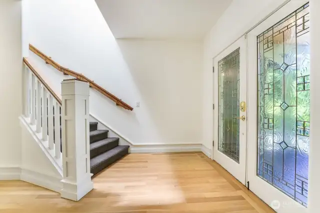 Beautiful glass french doors at the entry and freshly refinished white oak flooring.