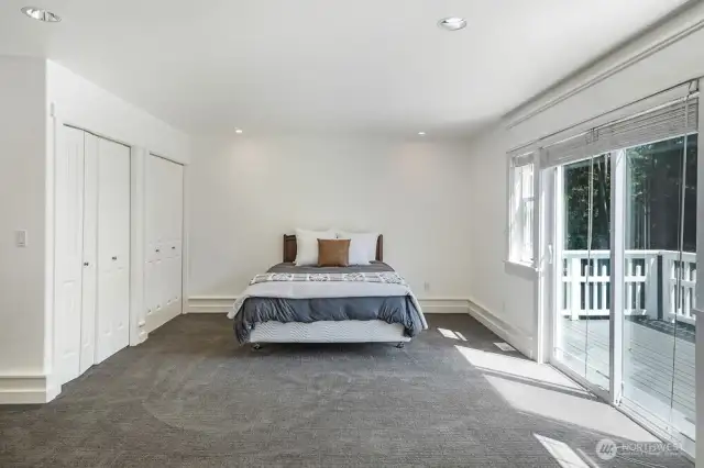 The primary suite features a private balcony, gas fireplace with new quartz slab facing, and an abundance of space.